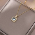 Close-up of gold necklace with a square pendant featuring a blue zircon and micro-pave crystals - Light Blue Round Main Stone Style (X3918) / Pendant about 18x10mm / Gold