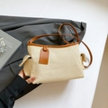Chic beige canvas shoulder bag with brown leather trim and side pockets in a variant view - Beige