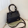 Chic black matte PU leather handbag with circular handle and adjustable shoulder strap - Black