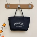 Minimalist black nylon tote bag with white lettering and woven rope handles for daily use - Black