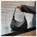 Detailed close-up of the black woven texture and leather craftsmanship of the hobo bag - Black
