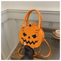 Detail of pumpkin-shaped handbag with spider web patterns and adjustable strap - Orange
