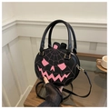 Detailed view of pumpkin-shaped handbag with pink spider web embroidery and dual handles - Black and Pink