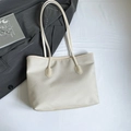 Minimalist beige woven tote bag with large capacity and sleek straps for daily commute - White