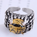 Macro shot of a punk dragon claw ring holding an amber evil eye bead with fine details - Amber Yellow Style (5#)