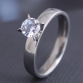 Detailed side view of silver steel ring with round cubic zirconia in four-prong setting - Silver