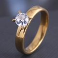 Macro view of gold stainless steel ring with a four-prong set round cubic zirconia stone - Gold