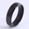 Close-up of a minimalist black polished stainless steel ring with a smooth finish - Black