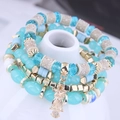 Multi-layer beaded bracelet featuring blue turquoise crystals and a golden owl charm - Blue