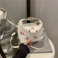 White corduroy crossbody bag with red cherry embroidery and metallic buckle strap - White