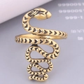 Macro shot of vintage gold snake ring featuring intricate scale textures and coiled design - Antique Gold Carved Style (3)