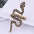 Macro shot of retro gold snake ring with detailed scale texture and raised head - Vintage Gold Wrapped Style (1)