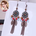 Detail of bohemian drop earrings with bronze leaf charms and colorful resin beads - Round