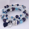 Close-up of three-layered blue beaded bracelets with silver clover and tassel charms - Style 3-Deep Blue Purple