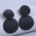 Detail shot of matte black double circle drop earrings with minimalist geometric design - Black