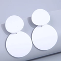 Minimalist white matte acrylic double circle drop earrings on purple backdrop - White