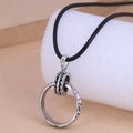 Retro hollow ring pendant necklace with black cord on a minimalist display stand - Circle Pendant (2082904)