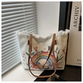 Close-up of canvas tote bag with floral butterfly print and white fringe edge detail - White