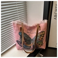 Detail of pink canvas tote bag with butterfly print and stylish fringe trim design - Pink