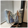 Detail of canvas tote bag featuring butterfly print and frayed edge design - Blue