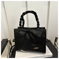 Detail of black leather handbag with braided handle and silk ribbon bow decoration - Black