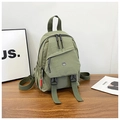 Mini sage green nylon backpack with dual buckles and zipper details on a wooden surface - Green
