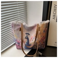 Detail of canvas tote bag showing artistic peacock print and fringe edge finish - Purple