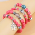 Detail of multi-layered pink matte bead bracelets with a silver tree of life charm - Rose Red
