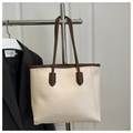 Close-up of a minimalist tote bag with beige leather, brown handles and contrast stitching - No Pendant / White