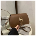 Detailed view of dark brown leather bag with golden D-ring buckle and textured strap - Brown