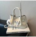 Detail of cream woven tote bag with adjustable strap and plush pom-pom charm - With Charm / White