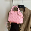 Pink patent leather shell bag featuring embossed check pattern and gold zipper detail - Pink