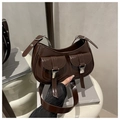 Detail of dark brown glossy patent leather underarm bag with silver metallic buckles - Brown