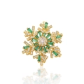Macro shot of snowflake brooch with emerald green baguette gems and clear cubic zirconia - Emerald Green Snowflake Style (XX0208)