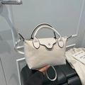 Chic beige dumpling handbag with black trim and adjustable strap for women in 2025 - Flap Handheld Style / Off-white Leopard
