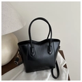 Detail of black leather bucket bag with FASHION engraving and golden metal hardware - Black
