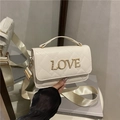 Beige quilted crossbody bag with gold LOVE lettering and wide textile shoulder strap - White