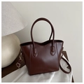 Detail of a dark brown crossbody bucket bag with embossed FASHION lettering on smooth leather - Dark Brown
