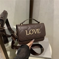 Dark brown quilted crossbody bag with gold LOVE metal letters and wide fabric strap - Brown