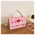 Detailed view of pink crossbody bag with cherry prints and 3D glitter cherry accents - Pink