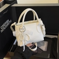 Mini white bucket bag with pebble leather texture and elegant pearl bow accessory - White with Pendant