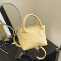 Bright yellow pebble leather mini bucket bag with gold lettering and adjustable strap - Yellow