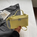 Elegant bright yellow lychee leather handbag with silver zippers and adjustable strap - Yellow