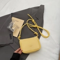 Bright yellow lychee grain leather crossbody bag with decorative knotted shoulder strap - Yellow