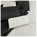 Detailed macro view of white long wallet featuring snakeskin texture and gold zipper - White