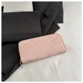 Detail of light pink long wallet featuring elegant snake pattern and gold zipper closure - Pink