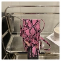 Pink faux leather snakeskin phone bag with long fringe and adjustable crossbody strap - Pink