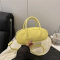 Chic bright yellow oval crossbody bag with glossy finish and detachable shoulder strap - Yellow