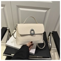 Detail of cream beige woven texture handbag with silver U-shaped clasp and leather trim - Off White