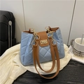 Quilted light blue tote bag with brown leather straps and gold twist lock closure - Blue